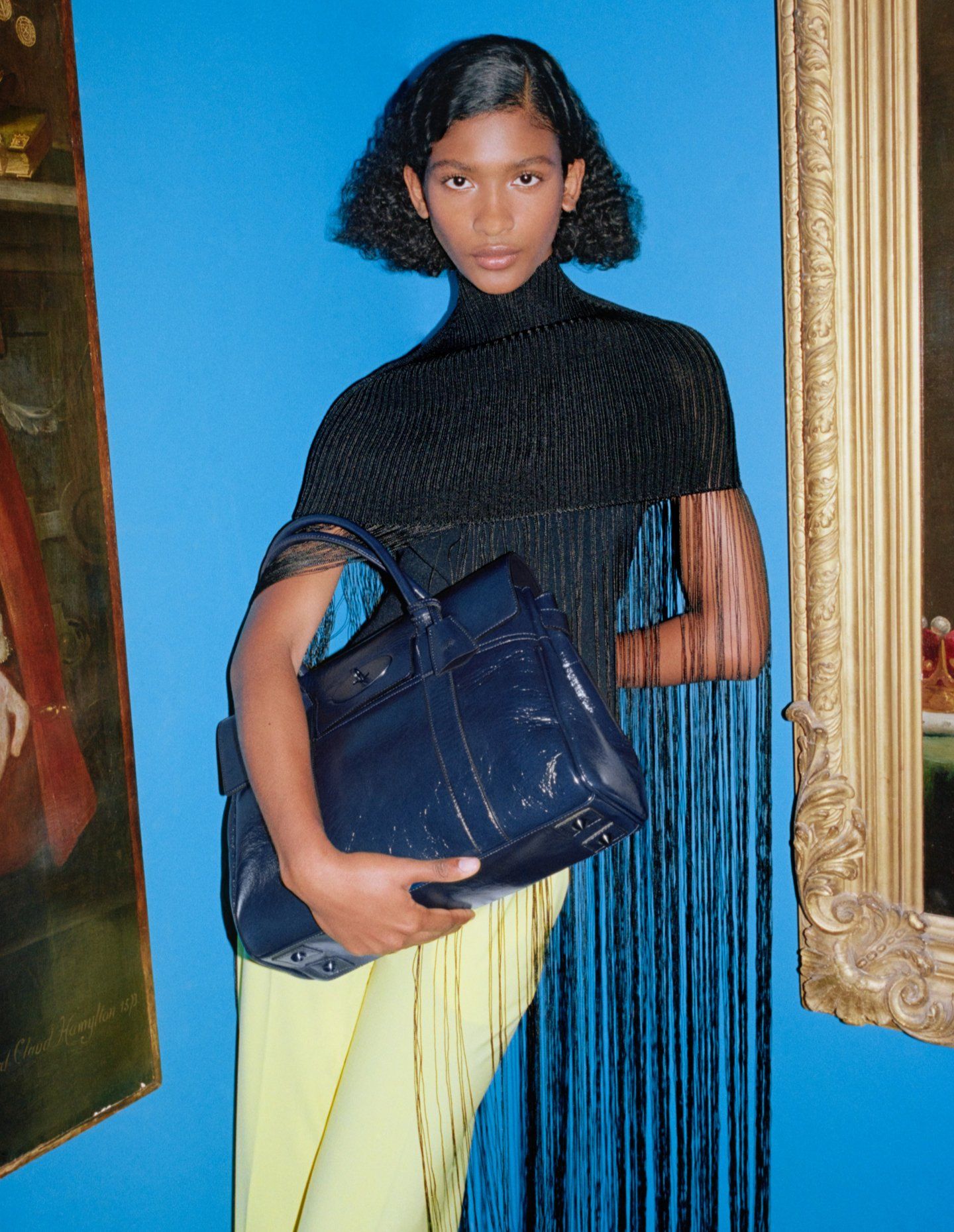 Model holding Mulberry Bayswater handbag in Sapphire
